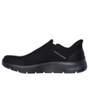 Side view of a black slip-on trainer with a mesh upper and textured sole. The design is sleek and modern, with 'Skechers Slip-Ins' branding.