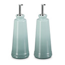 Two light blue bottles, one has Le Creuset branding.