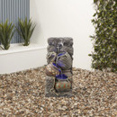 A water fountain with a tap pouring into the jugs below