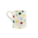 A side view of a white mug with multicoloured polka dots on a white background