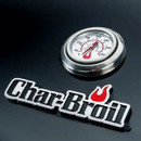 A stainless steel grill thermometer next to a Char-Broil logo on a glossy black surface.