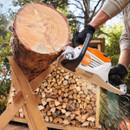 A close up of the chainsaw cutting logs