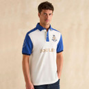 A man wearing a stylish white polo shirt with blue sleeves and 'JOULES' prominently displayed on the chest.