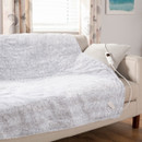 A view of a grey heated blanket on a sofa