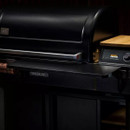 Traeger pellet grill with P.A.L. Pop-And-Lock front shelf attached