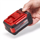 A hand holds an Einhell 18V Li-ion battery, featuring a red and black design with the "POWER X-Change" label visible.