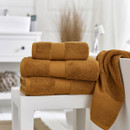 A bale of yellow towels with one draped over the bath