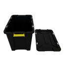A black storage box with its lid on the floor.