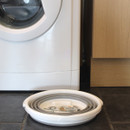 The bucket collapsed next to the washing machine