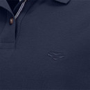 Close-up of a navy polo shirt with a subtle embroidered logo and a classic collar featuring a striped detail. Close-up of a navy polo shirt with a subtle embroidered logo and a classic collar featuring a striped detail.