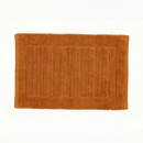 An orange bath mat on a white background.