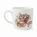 A white ceramic mug featuring a charming illustration of a cat resting in a basket surrounded by colourful flowers and foliage.