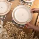 A view of a cream Woodbury Lane side plate with an etched piglet design