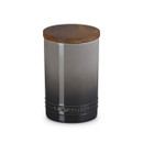 A grey stoneware jar with a wooden lid.