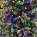 Close-up of an artificial pine tree adorned with colourful Christmas lights in red, blue, green, and yellow, creating a festive ambiance.