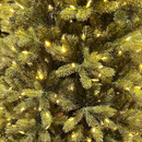Close-up of a Christmas tree's lush green branches adorned with warm white lights, creating a festive and cosy atmosphere.
