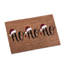 A festive doormat featuring the playful phrase "HO HO HO," adorned with red Santa hats and a natural coir background.