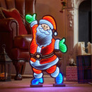A colourful illuminated Santa Claus figure with bright red, green, and blue accents, cheerfully waving in a cosy, festive setting.