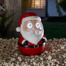 Illuminated Santa Claus Christmas decoration with glowing animated eyes, red suit and festive hat, designed for indoor or outdoor seasonal displays.