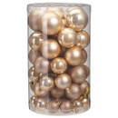 A clear cylindrical container filled with assorted gold and bronze Christmas baubles, including shiny and glittery finishes.
