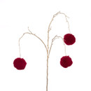 A gold stem with red pom poms hanging on the ends