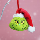 Close-up of a Grinch head Christmas tree decoration with embroidered face and red Santa hat