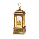 Antique gold Christmas lantern featuring an illuminated festive scene with swirling glitter effect, warm LED lighting and ornate vintage-style detailing for seasonal home decoration.