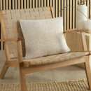 A view of a cream design cushion on a chair