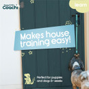A small dog near a door with a tag that reads "Makes house training easy!" Promoting training solutions for puppies and dogs over 8 weeks.