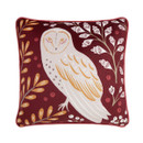 A view of a reversible red cushion with an owl on a white background