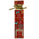 Red and gold packaging for Starlytes Apple Cinnamon reed diffuser, adorned with festive designs and a green ribbon.