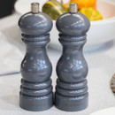 A pair of dark grey salt or pepper mills