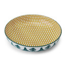 A green leafy bowl with a yellow geo design inside.