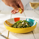 A yellow abstract design bowl with food inside.