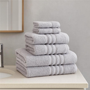 A view of all the Catherine Lansfield Zero Twist Cotton Towels in silver stacked on a counter top