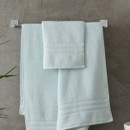 A view of a blue Catherine Lansfield Zero Twist Cotton Hand Towel on a rail