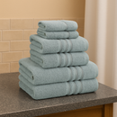A view of all the Catherine Lansfield Zero Twist Cotton Towels in blue stacked on a counter top