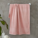 A view of a pink Catherine Lansfield Zero Twist Cotton Bath Towel on a on a rail