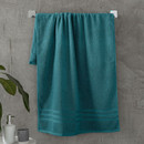 A view of a teal Catherine Lansfield Zero Twist Cotton Bath Towel on a on a rail