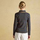 A woman with a neatly styled bun wearing a navy and tan brown striped long-sleeve shirt, seen from behind against a textured, light background.