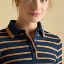 A close-up of a woman wearing a navy and tan brown striped polo shirt with a classic collar and button placket.