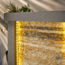 Close-up of a textured stone wall with warm LED lighting, highlighting natural patterns and a serene atmosphere.