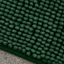 A close up view of a green Catherine Lansfield Bobble Bath Mat on a tiled floor