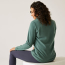 The back of a woman wearing a deep green fleece.