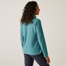 The back of a woman wearing a light blue coloured fleece.