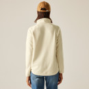 Back view of the cream half-zip fleece showing the plain back and long sleeves, styled with jeans and a cap.