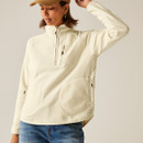Angled view of the cream half-zip fleece showing the relaxed fit, side zip pocket and high collar.