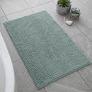 A view of a sage Catherine Lansfield bobble bath mat on a tiled floor