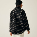 The back of a woman wearing a borg fleece with a black and light vanilla coloured abstract print.