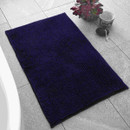 A view of a navy Catherine Lansfield bobble mat on a tiled floor